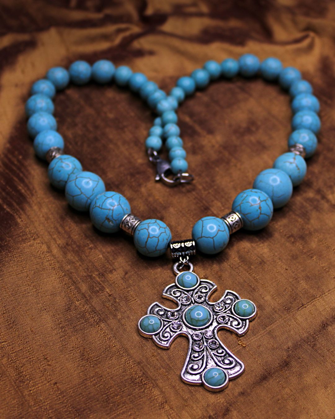 Large silver colored cross with turquoise accents. Large turquoise color necklace. Statement piece. 