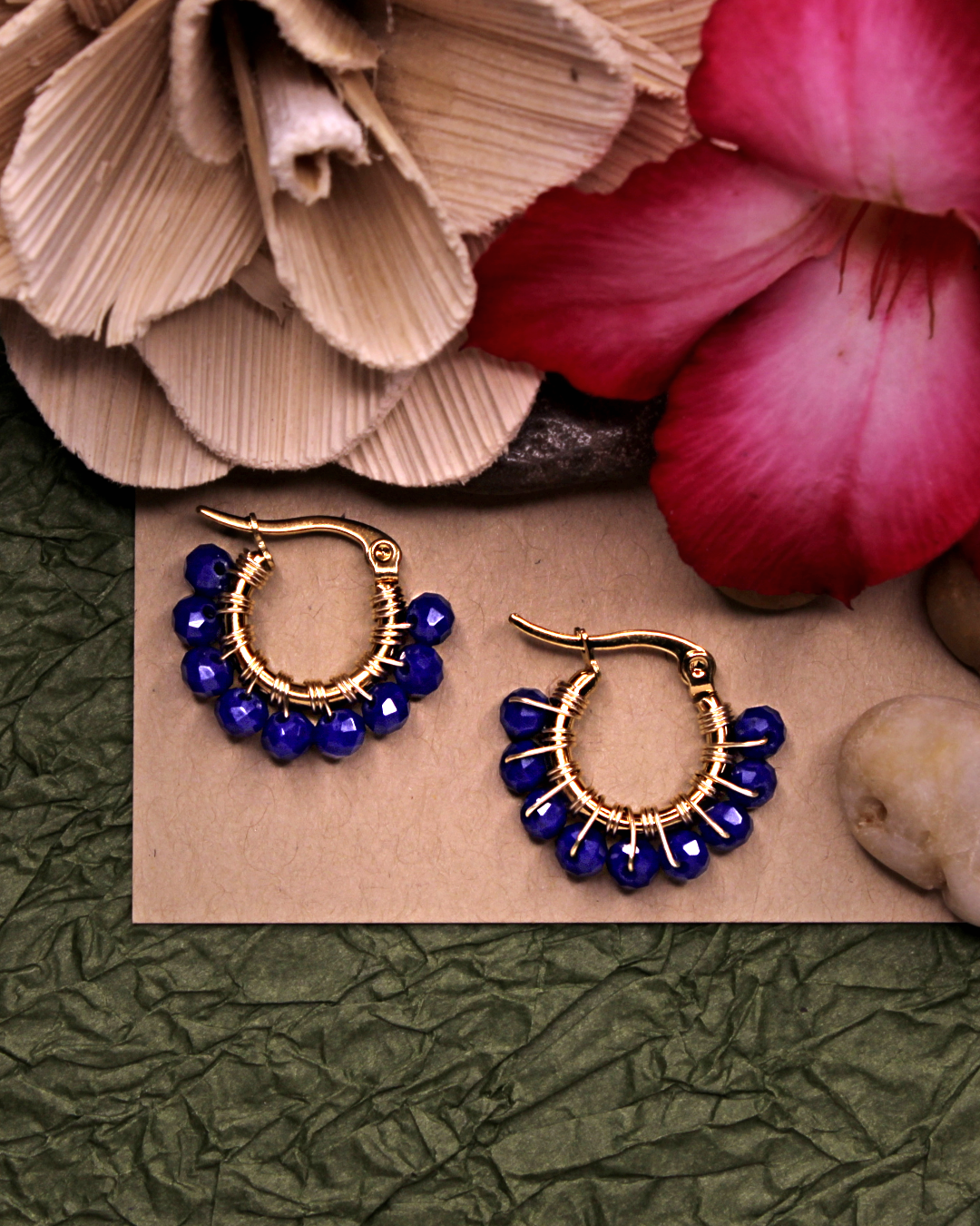 Mini stainless steel gold hoop earrings with blue crystal beads. 