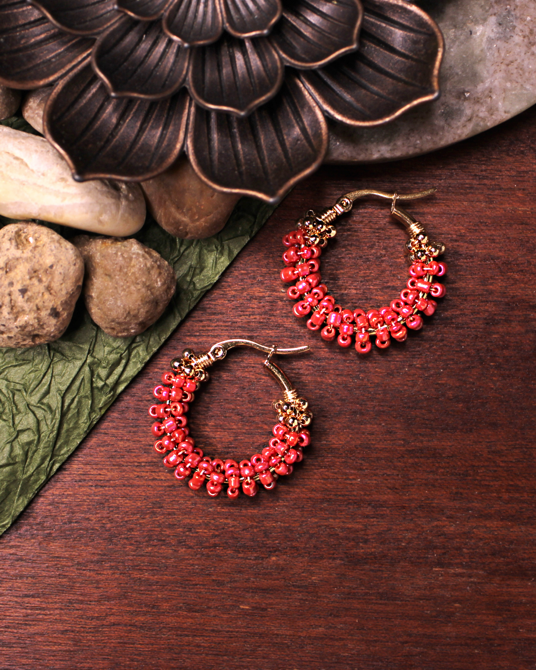 Small stainless steel gold colored hoop earrings with salmon colored crystal seed beads.