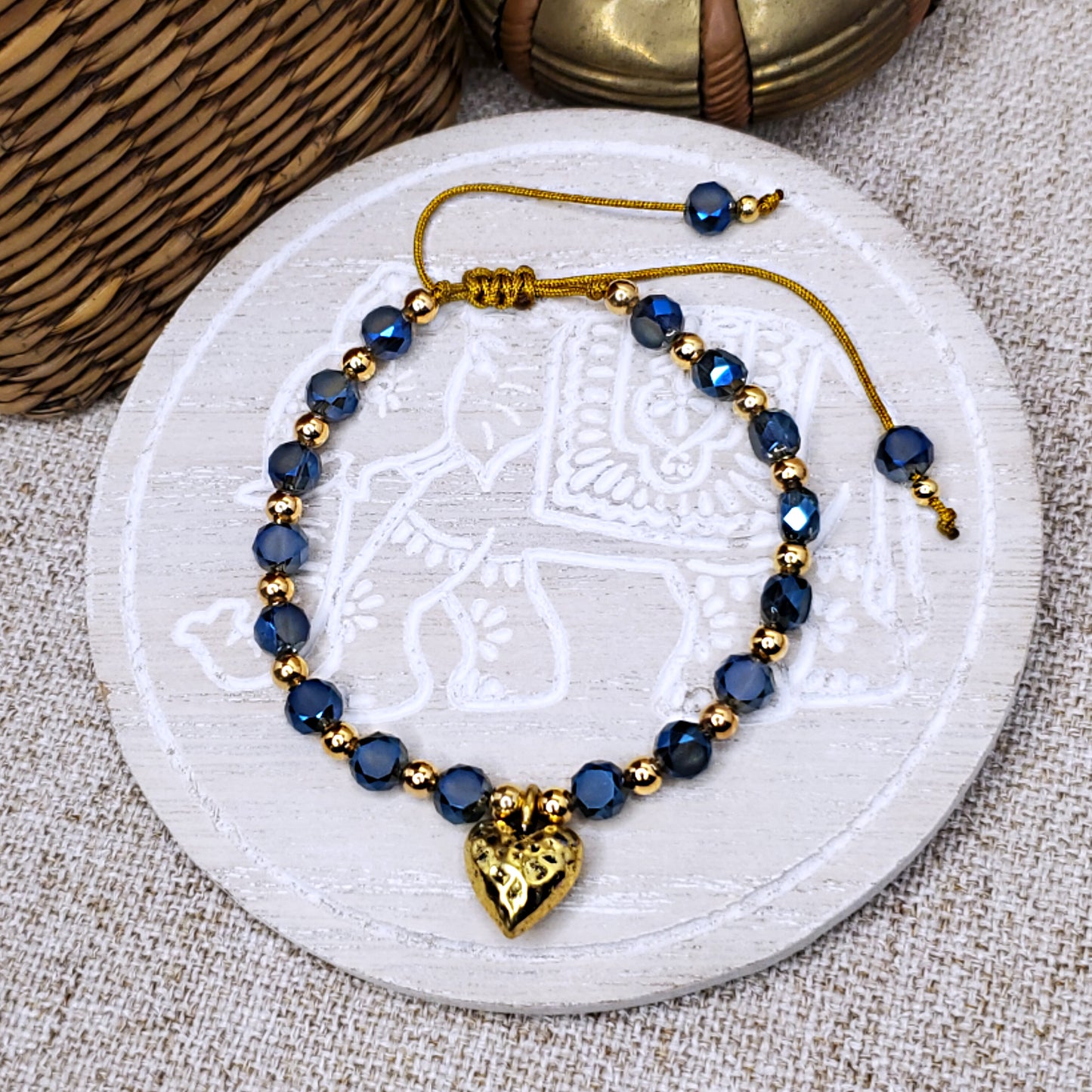 Gold heart charm with blue crystal beads adjustable bracelet.