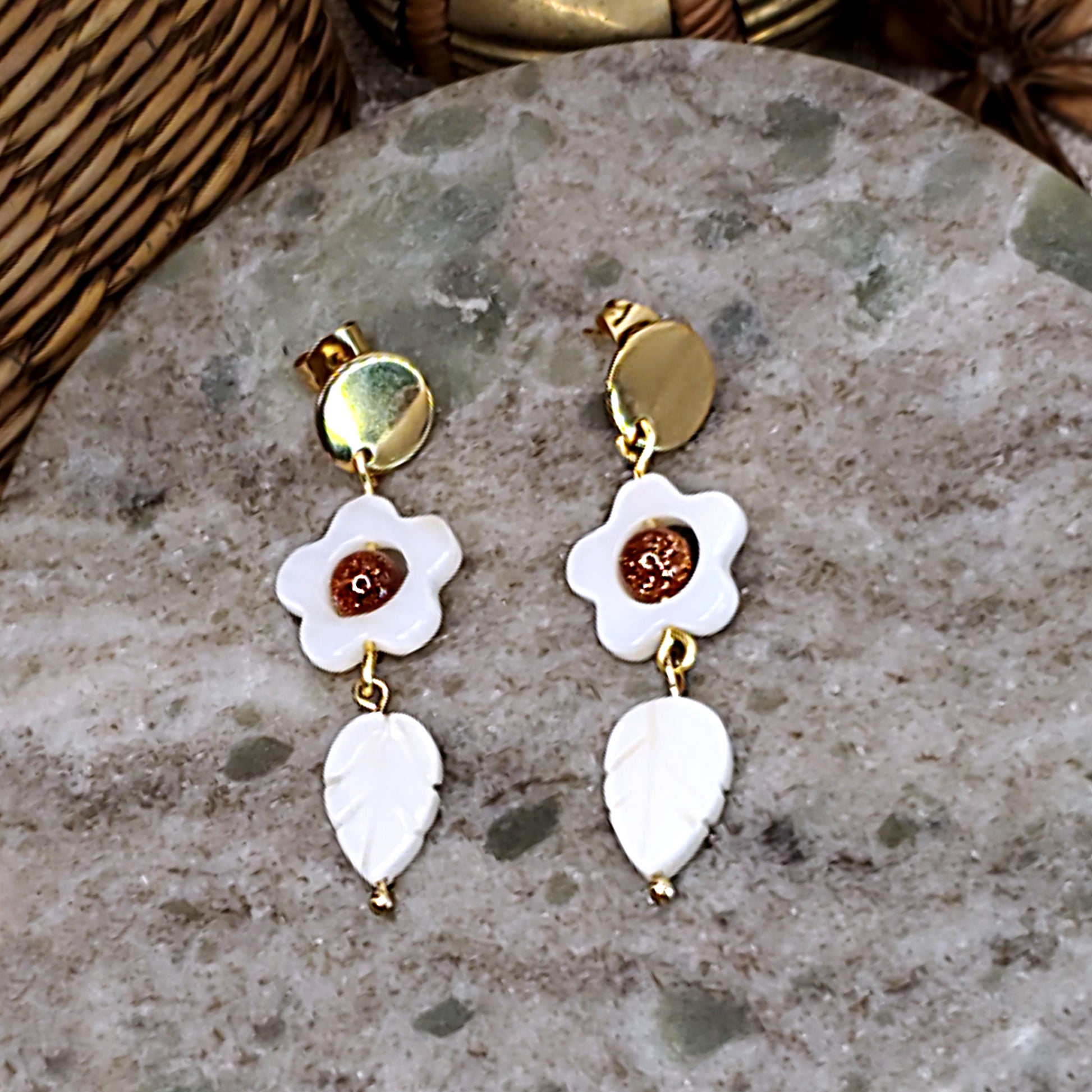 White daisy dangling earrings with sparkling bead on center.