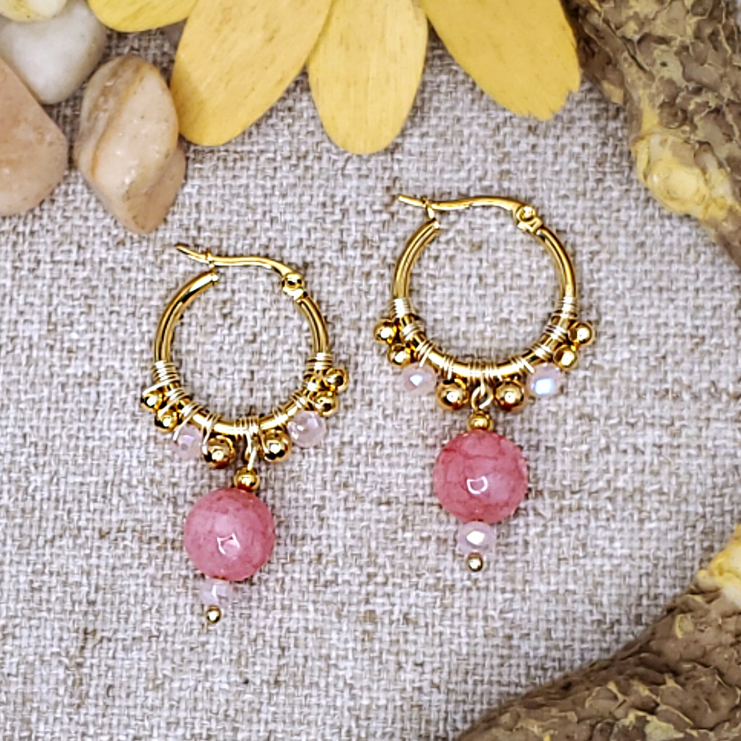 Small gold hoop earrings with faceted pink jade bead. 