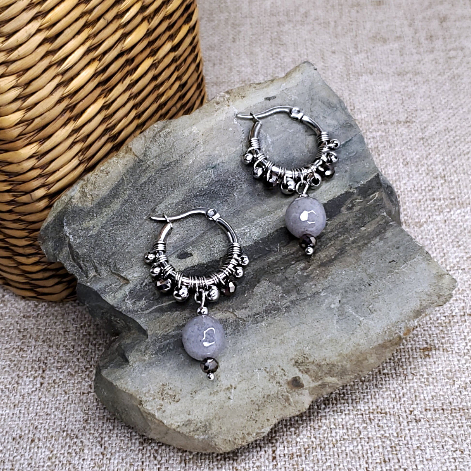 Stainless steel dangling earring hoops with gray jade beads.