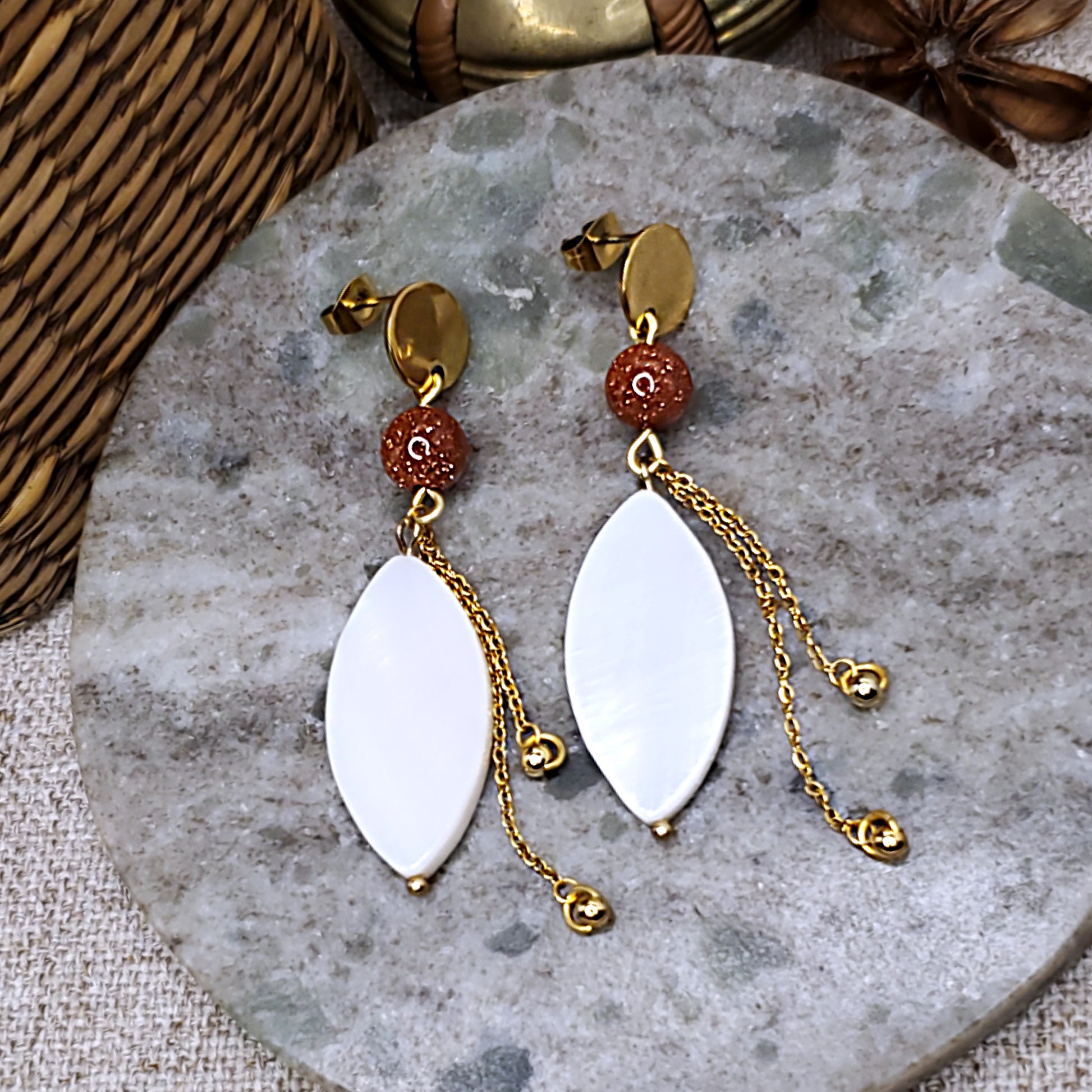 White petal dangling earrings with chain accent.